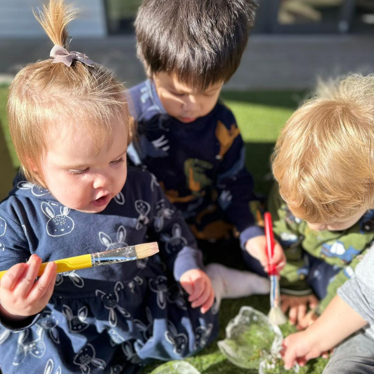 Toddlers playing with bubbles outdoors at Busy Bees Silverdale Central