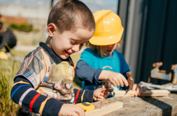 Children engaged with construction play outdoors