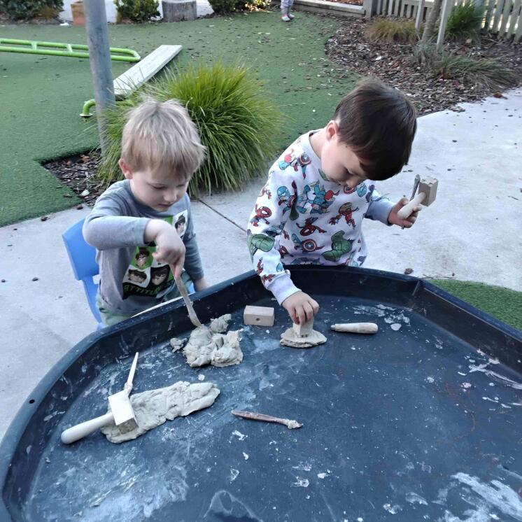 Tamariki building at the drafts table outdoors in timaru and Busy bees aoraki