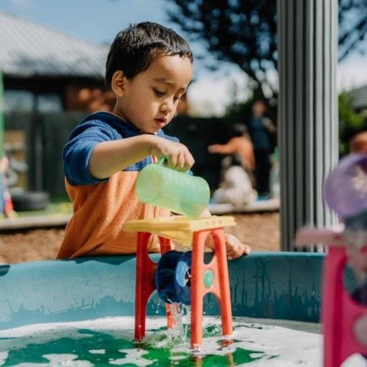 Busy Bees Avonhead preschool boy learning cause and effect in water play