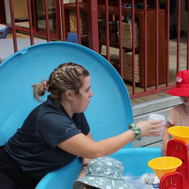 Busy Bees Carterton outdoor water play with teachers and tamariki
