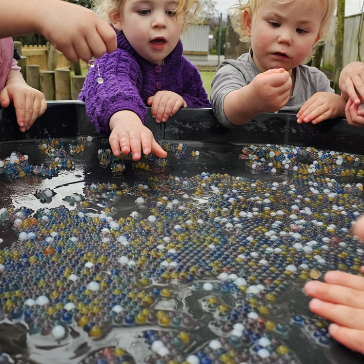 Sensory exploring in toddlers room at Busy Bees Carterton childcare