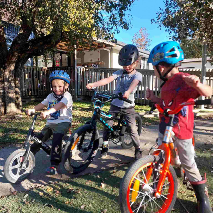 Boys riding bikes in our centre at Busy Bees Greytown