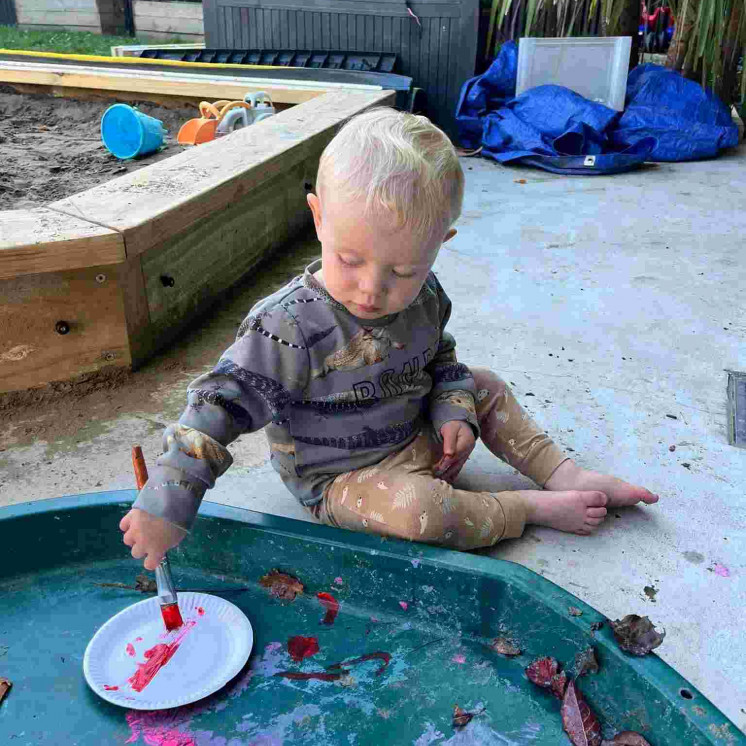 Baby in messy water play at Busy Bees Greytown