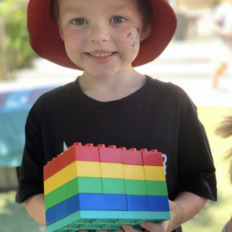 Preschool boy proud of his colourful creation with blocks at Busy Bees Havelock North