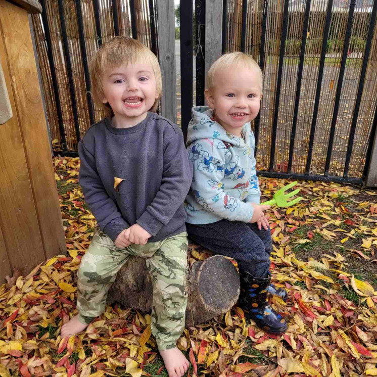 Busy Bees Havelock North two boys in the autumn leaves