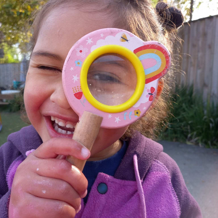 Learning with magnifying glasses at Busy Bees Havelock North