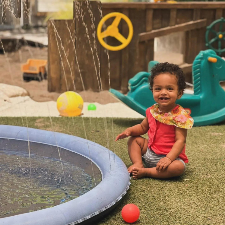 Little girl enjoying outdoor water play at Busy Bees Havelock North