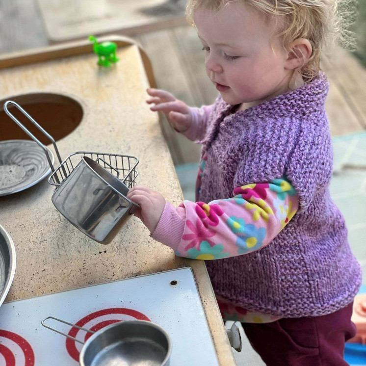 Busy Bees Havelock North babies enjoying the outdoor kitchen space