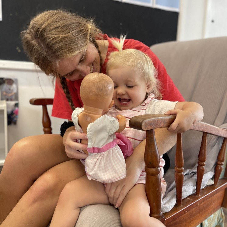 Busy Bees Martinborough childcare centre nursery teacher and baby playing and bonding