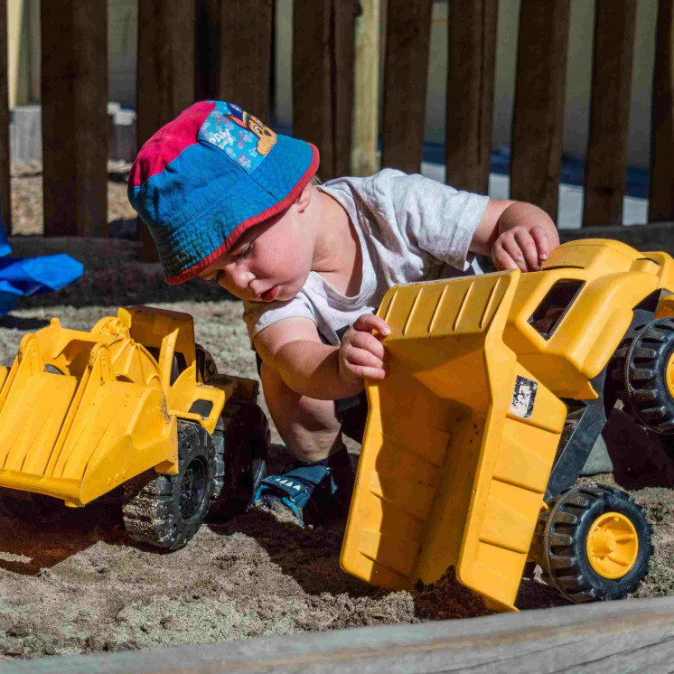 Toddler engaged in real world play at  Busy Bees Morrinsville