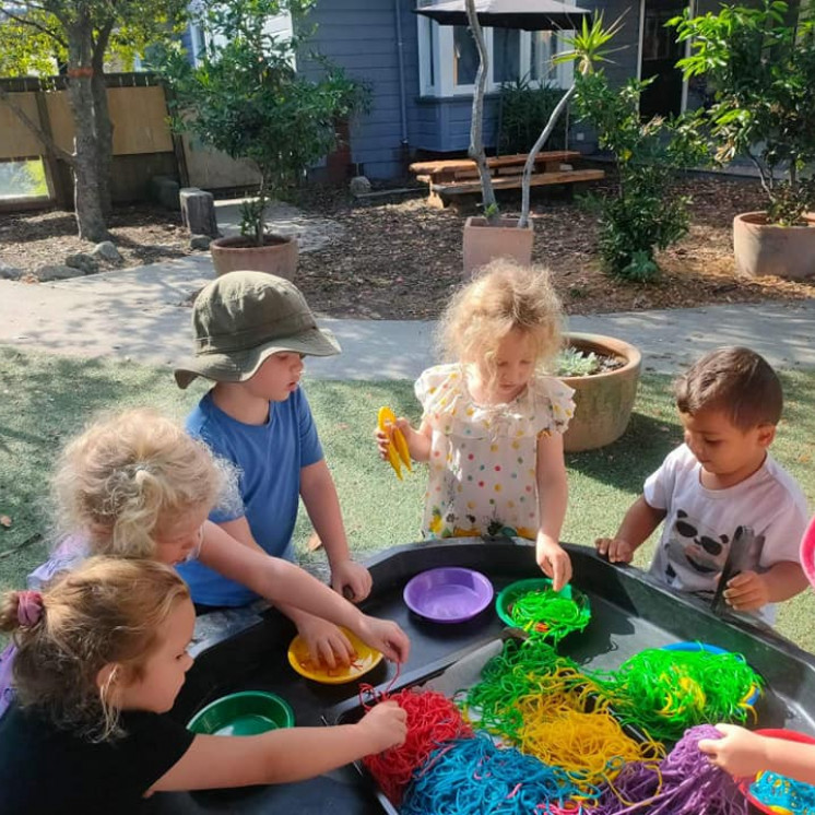 Preschoolers learning with coloured spaghetti at Busy Bees Motueka Childcare