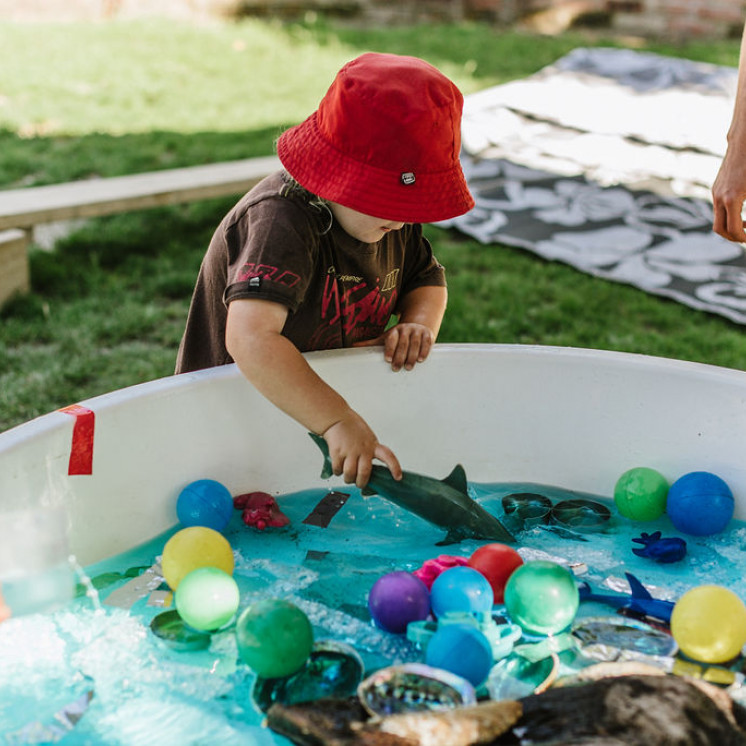 Young child engaged in waterplay at Busy Bees Motueka Childcare