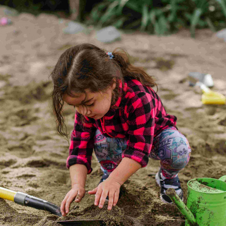 Young girl engaged in sandpit play at Busy Bees Motueka Childcare