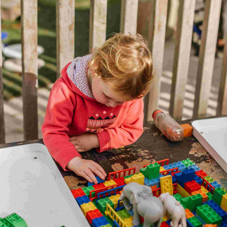 Boy enjoying creating a Lego house for the zoo animals at Busy Bees Motueka Childcare