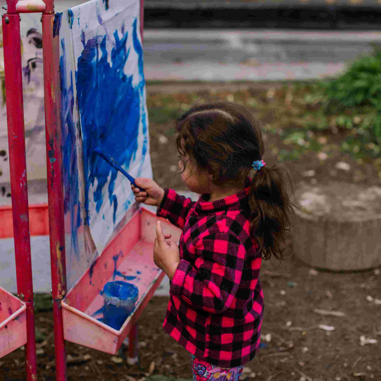 Expression through painting outdoors at Busy Bees Motueka Childcare