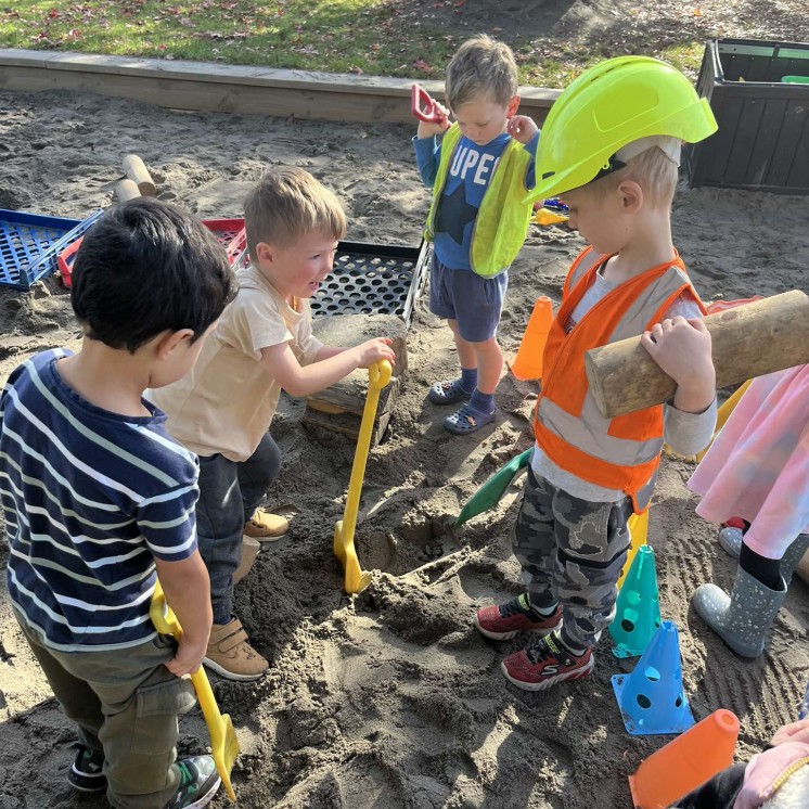 Kids digging in sand 
