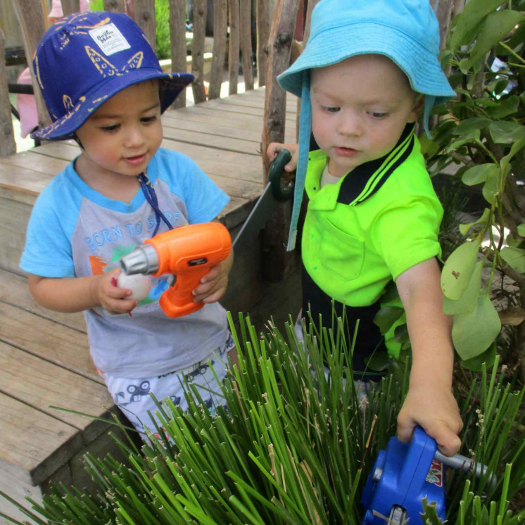 Toddler boys gardening and engaged in real play at Busy Bees Ngongotahā 