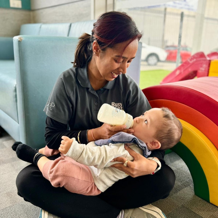 Teacher and baby nurturing moment at Busy Bees Ormiston 