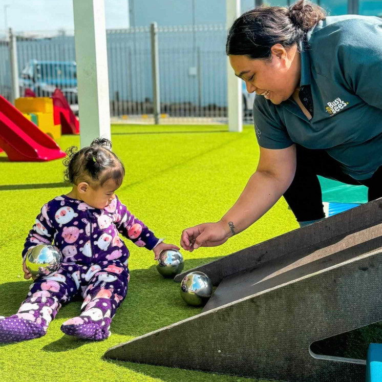 Baby learning fine motor skills at Busy Bees Ormiston