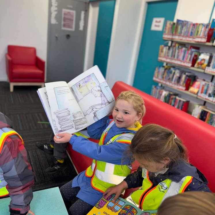 Busy Bees Pahiatua Girl showing off her book