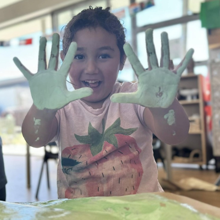 Busy Bees Papamoa Beach painting with hands