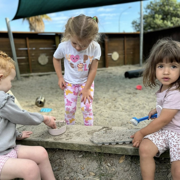 Busy Bees Papamoa Beach playing in sand pit