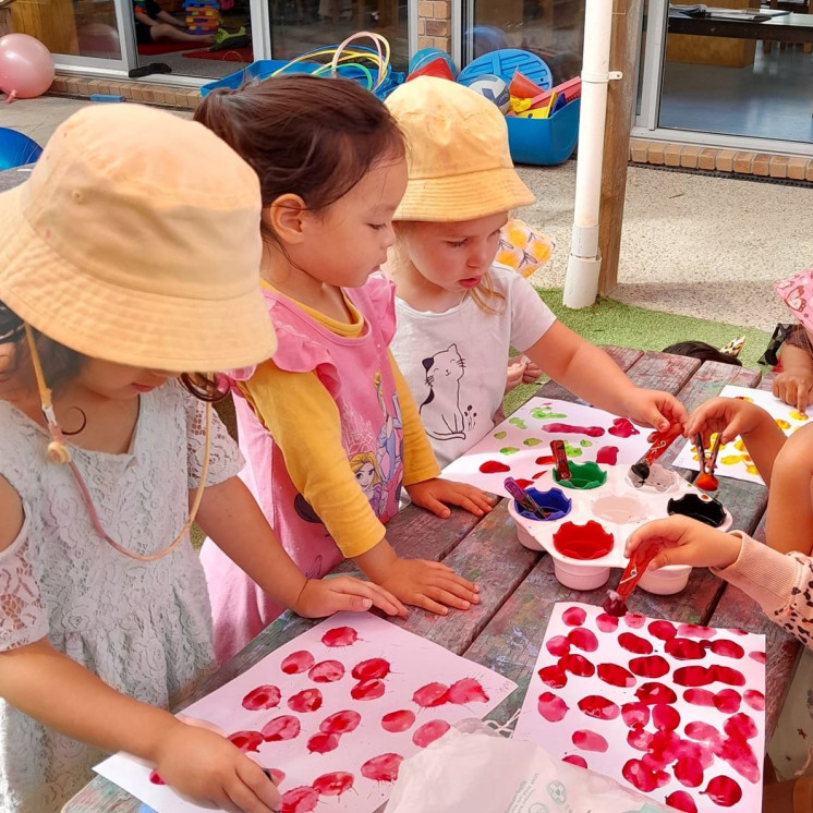 Preschoolers creating with paint and textures at Busy Bees Pukekohe