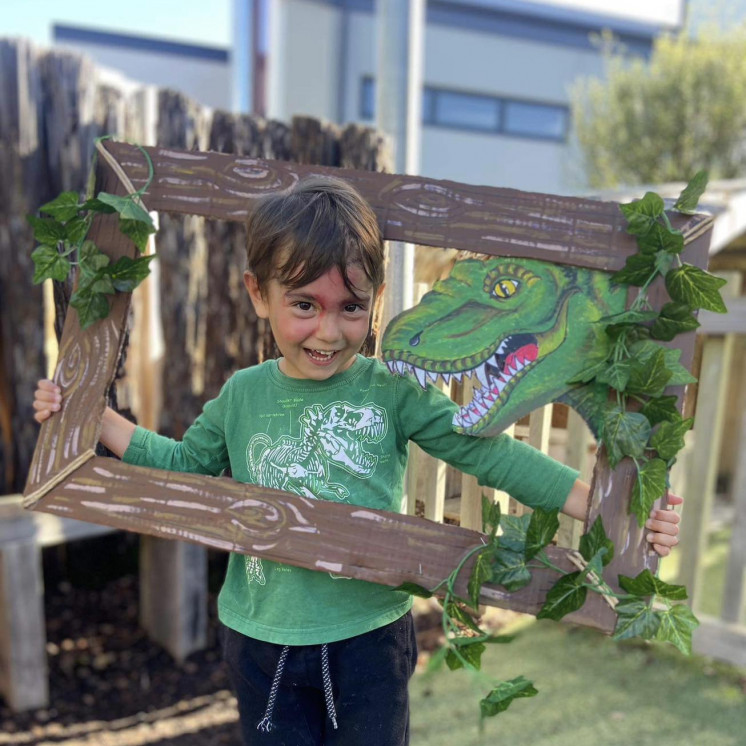 Child outdoors with photo frame at Busy Bees Silverdale Central
