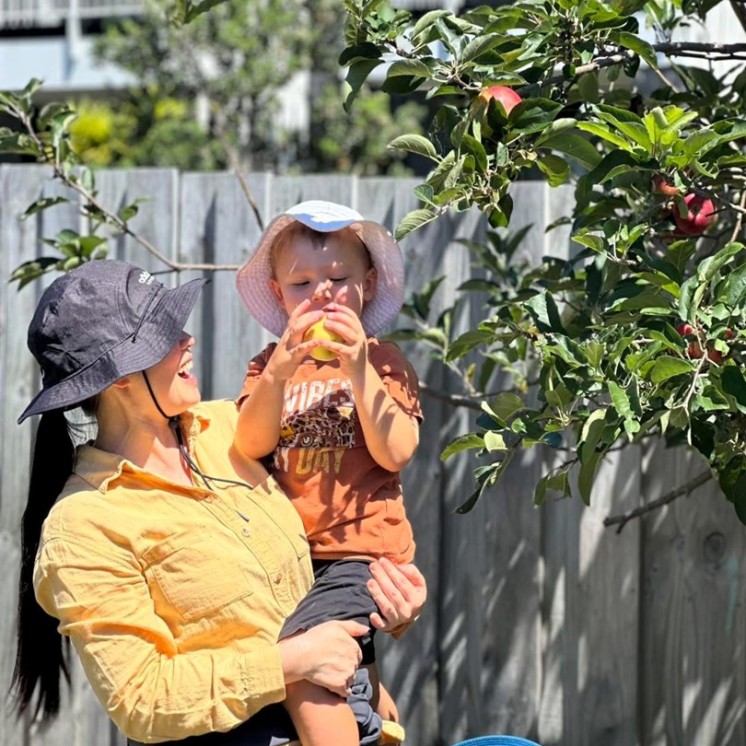 Teachers care fresh fruit outdoors childcare nurture