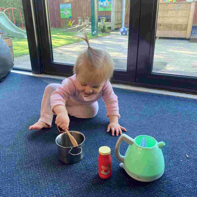 Real world play with real items in babies room at Busy Bees Southbrook
