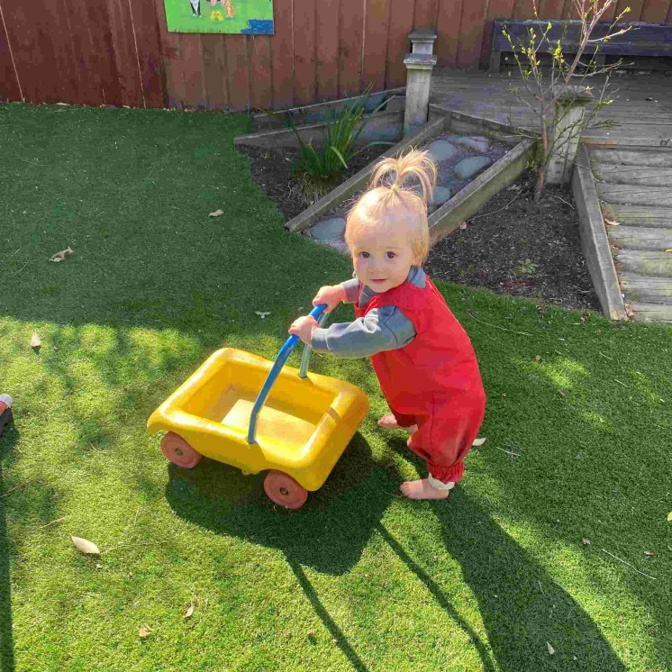 Baby walking outdoors at Busy Bees Southbrook