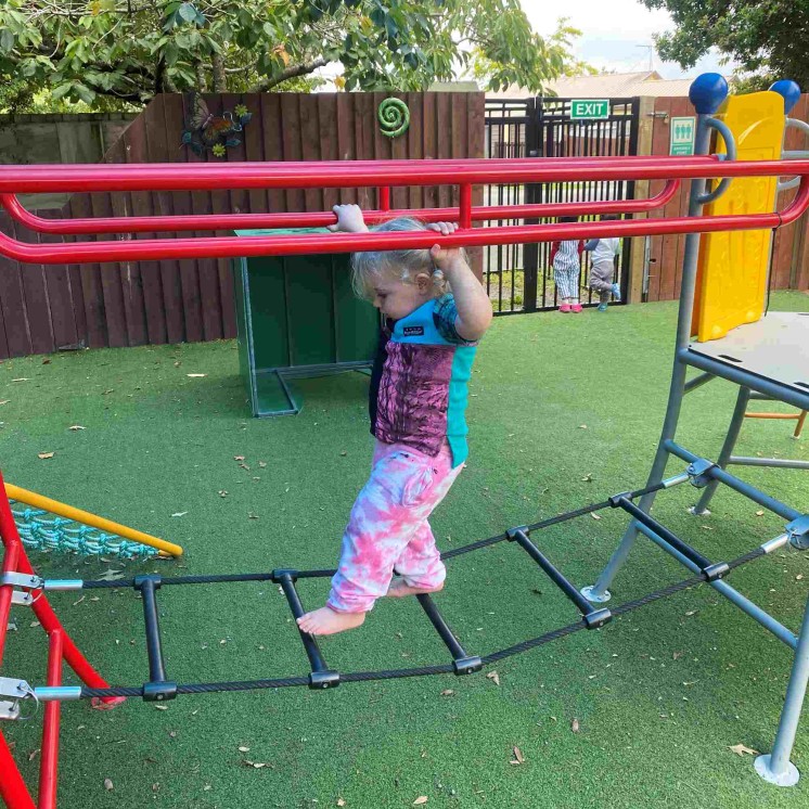 Outdoor balancing skills for toddler girl at Busy Bees Southbrook Childcare 