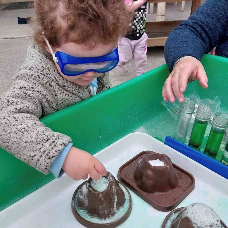 Preschool boy practising science volcanic eruption at Busy Bees Southbrook childcare 