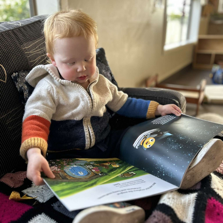 Busy Bees Tahunanui young boy reading a Busy Bees book