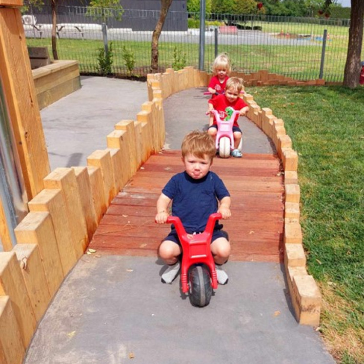 Nursery children enjoying racing around on the new bike track at Busy Bees Te Mata Road