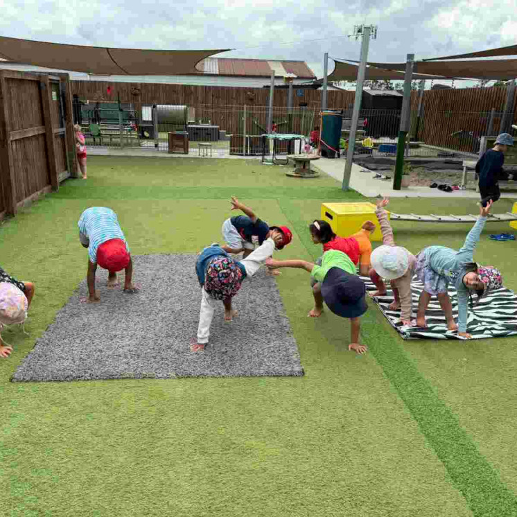Pre-schoolers participating in Yoga outdoors 