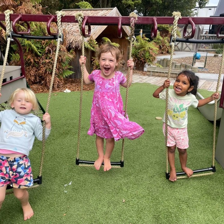 HOW Cambridge girls playing on swing