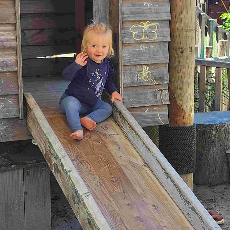 Girl sliding down wooden fort at House of Wonder Gisborne