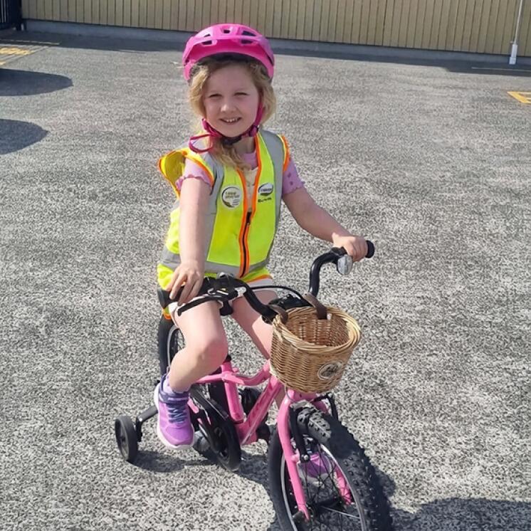 Little Coasties by Busy Bees Manly Whangaparaoa girl on bike safety helmet